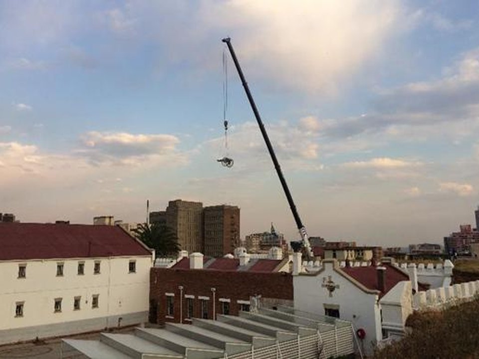 Cannon being lifted by crane onto the ramparts