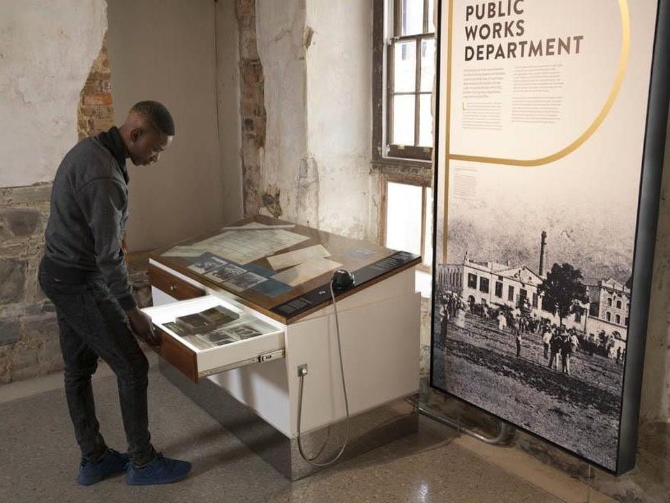 Visitor exploring archive exhibit, Old Granary