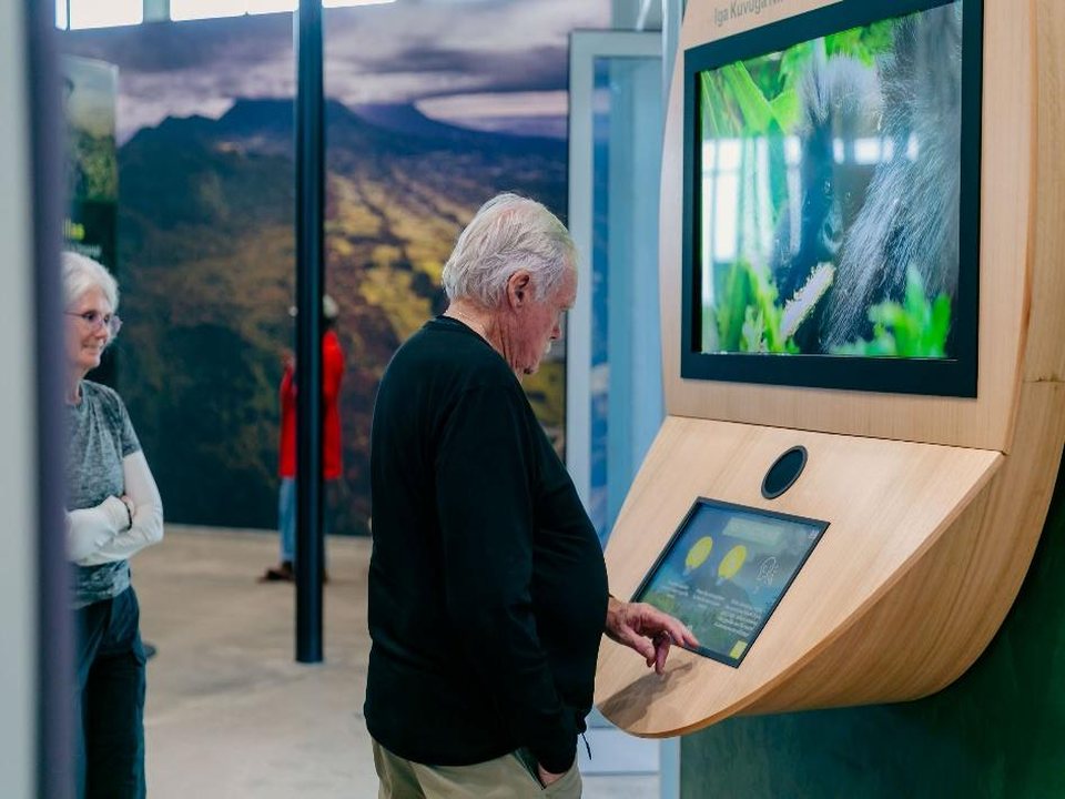 Visitor at interactive kiosk, Dian Fossey visitor centre
